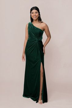 a woman in a green dress posing for the camera