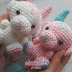 two crocheted stuffed animals are being held by someone