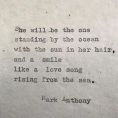 an old typewriter with the words she will be the one standing by the ocean with the sun in her hair and a smile like a love song rising from the sea