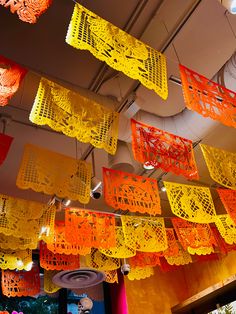 many orange and yellow lights hanging from the ceiling