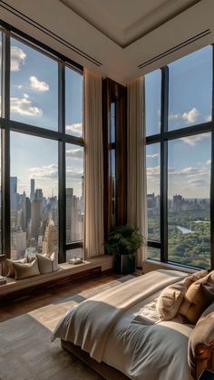 a bedroom with large windows and a view of the city skyline in new york, ny