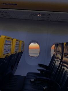 the inside of an airplane with two seats facing out to sea at sunset or sunrise