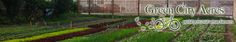 the green city herbs sign is in front of rows of plants and vegetables growing inside them