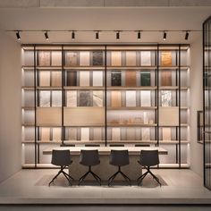 a room with several chairs and shelves filled with books