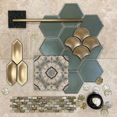 some gold and silver items sitting on top of a tile floor