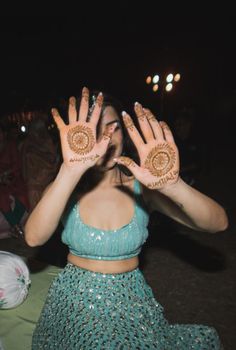 a woman with her hands painted in hendi