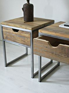 two wooden tables with metal legs and drawers on each side, one has a potted plant in the middle