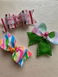 There dog hair bows - pink/brown lace stripe dog bow, green polka dog dog bow, and neon zebra dog bow