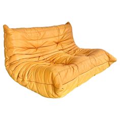 a yellow leather futon is shown against a white background