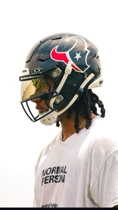 a man with dreadlocks wearing a football helmet