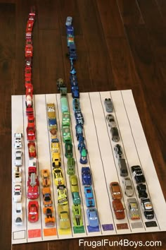 a bunch of toy cars sitting on top of a wooden floor next to each other