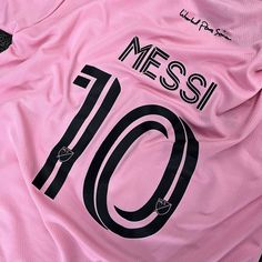 a pink soccer jersey with the number 10 on it's chest and black lettering