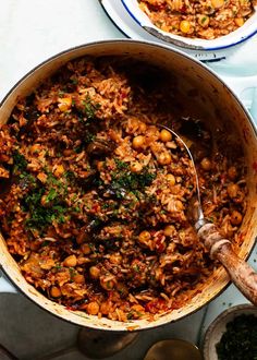 two pans filled with food sitting on top of a table next to each other