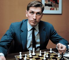 a man in a suit and tie playing chess