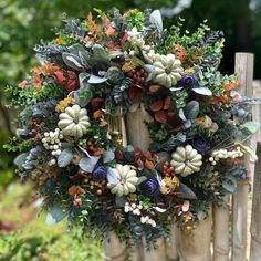 a wreath on top of a wooden fence