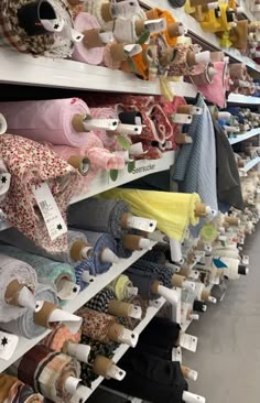 the shelves are filled with different types of fabrics