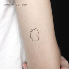 a person with a small tattoo on their arm that has a map of the country