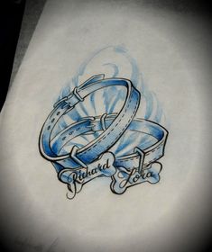 a drawing of two blue rings with the words tattoo love on it's side