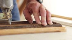 a person using a drill to cut wood