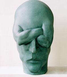 an advertisement with a green head and hands covering it's eyes in front of a white background