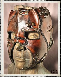 This unique and fully handmade mask is made of 6-7 oz veg tanned leather dyed with a warm dark-brown, treated with a leather satin acrylic finisher. Leather straps, black stiches and bronze plated rivets adorns this creation. The buffalo leather strap have a roll buckle made from steel and brass plated. It's long enough to any size of head or top hat, attached to the frame with brass plated rivets. Extralong straps are available, just ask for it. If you have any question or want something simila Leather Face Mask, Handmade Mask, Apocalyptic Fashion, Scary Faces, Leather Mask, Cool Masks, Leather Dye, Masks Art, Gadgets And Gizmos