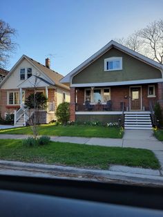 a house with grass and trees in the front yard