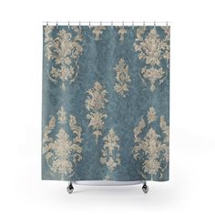 a shower curtain with an ornate pattern on the front and back of it, in teal