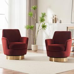 two red chairs sitting on top of a white rug