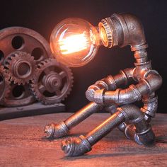 Industrial Nightstand Light: Metallic Silver Table Lighting Robot Pipe With Exposed Bulb Design Pipe Lamp Robot, Industrial Nightstand, Lampe Steampunk, Steampunk Table Lamp, Robot Lamp, Nightstand Light, Retro Table Lamps, Industrial Table Lamp, Table Lighting