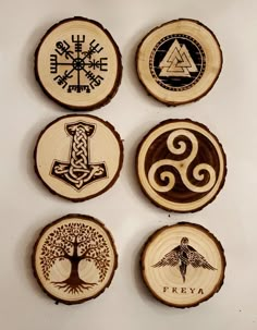 four wooden slices with different designs on them