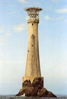 a light house sitting on top of a rock in the ocean