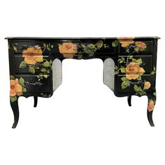 a black desk with yellow flowers painted on it