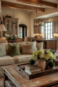 a living room filled with furniture and lots of pillows on top of a wooden table