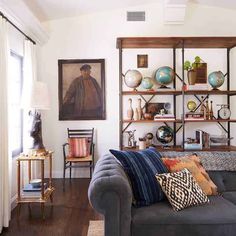 a living room filled with furniture and lots of bookshelves on top of it