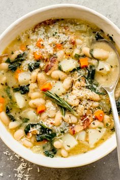 a white bowl filled with soup and vegetables