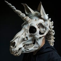 a man wearing a unicorn mask with horns