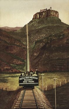 an advertisement for castle mountain railway and park on railroad tracks with mountains in the background