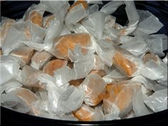 a bowl filled with oranges wrapped in plastic