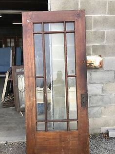 an old wooden door with glass on the outside