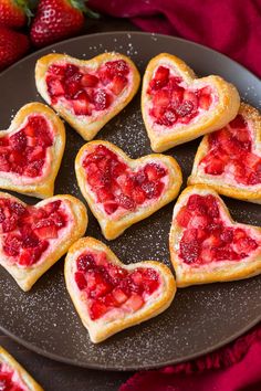 heart shaped strawberry shortbreads on a plate with strawberries