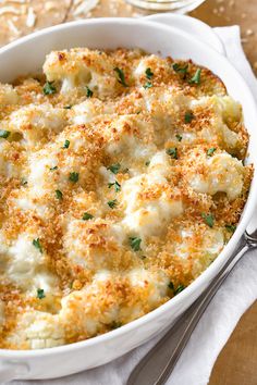 a casserole dish with cheese and parmesan bread on the side, ready to be eaten