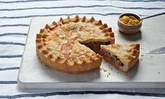 a pie sitting on top of a white cutting board