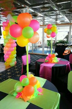 balloons and streamers decorate tables at an event