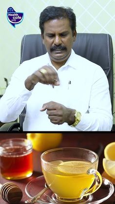 a man sitting in a chair next to a cup of tea and honey on a plate