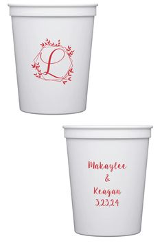 two white cups with red lettering on the bottom and one has a monogrammed design