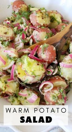 a white bowl filled with potato salad next to a wooden spoon and text overlay that reads warm potato salad