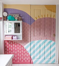 a kitchen area with painted walls and cabinets