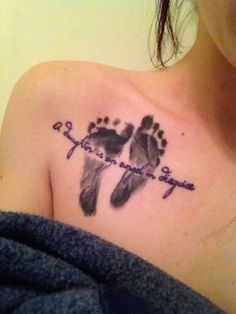 a woman with a cross and footprints tattoo on her chest