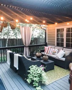 an outdoor living area with furniture and lights