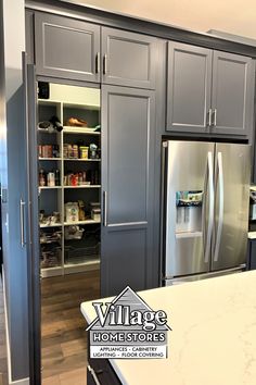 a kitchen with gray cabinets and stainless steel appliances